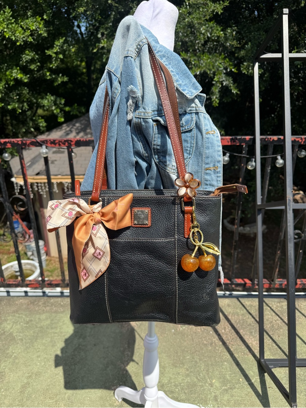 Dooney & Bourke Black Leather Tote with Brown Handles and Orange Charm